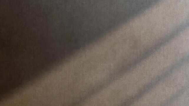 Diagonal light and shadow on concrete wall in minimalistic style on neutral backdrop, concept of calm and simplicity
