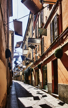 Borgo Giacomo Tommasini, a historic street known for its unique overhead decoration of dozens of suspended mirrors angled across the narrow alley located in the center of Parma, Italy, Europe 