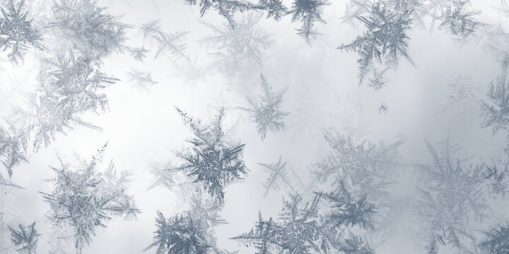 Winter frost patterns with crystalline ice structures on transparent surface for seasonal holiday decorations.