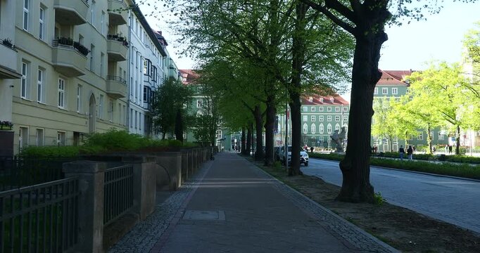 Walking Along John Paul II Avenue in Szczecin Poland - Walking along John Paul II Avenue in Szczecin, Poland. Historic apartment buildings and trees line the street near City Hall.