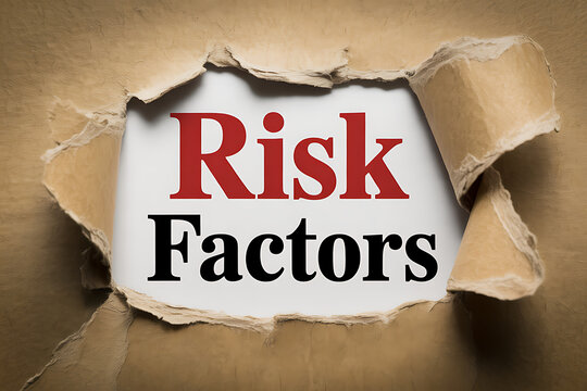A torn cardboard reveals Risk Factors written in bold letters inside