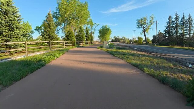 Immersive POV from a slow recumbent trike ride on a bike trail along a street in Fort Collins, Colorado