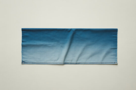 The hhh 76 concept showcases blue jeans on a white background with a focus on fabric texture and clothing detail in a still life product photography setting.
