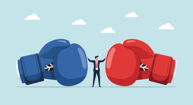 Conflict resolution business concept showing man standing between large blue and red boxing gloves representing competition rivalry negotiation and mediation.