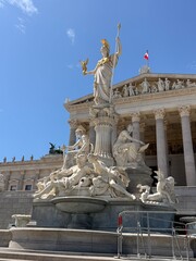 Obraz premium Austrian Parliament building and Pallas Athena fountain in Vienna Austria