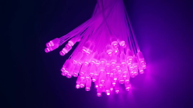 Fiber optic cable bundle glowing with blue light strands in futuristic tunnel for technology visuals and network concepts