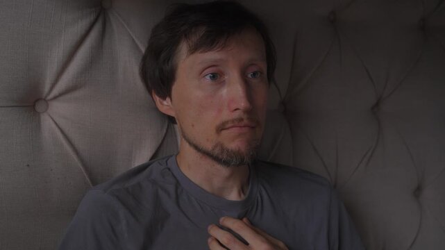 Middle aged man hiccupping. High quality audio recording. Natural body reaction captured in real time. Everyday human condition, spontaneous reflex and authentic lifestyle concept.
