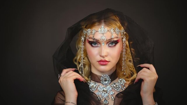 Fantasy mystery girl, dark queen woman beauty face eyes looking at camera, luxury elf girl, black dress hood blonde hair royal person fashion model posing silver jewelry victorian historical style.
