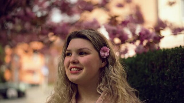 Young woman posing in soft spring light outdoors, natural beauty portrait, lifestyle video in Czech Republic, Europe, commercial use
Young woman with curly hair looking at camera outdoors, natural lig