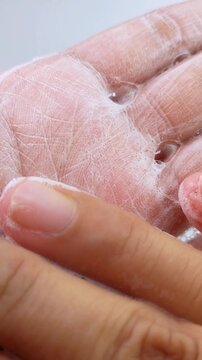 Rubbing palm slowly with cleansing soap. Close up view of hand washing process, skin hygiene concept, refreshing daily care routine on clean background.