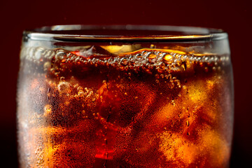 Fototapeta premium Fizz sparkling cola bubbly soda pop with ice cubes.