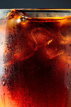 Fizz sparkling cola bubbly soda pop with ice cubes.