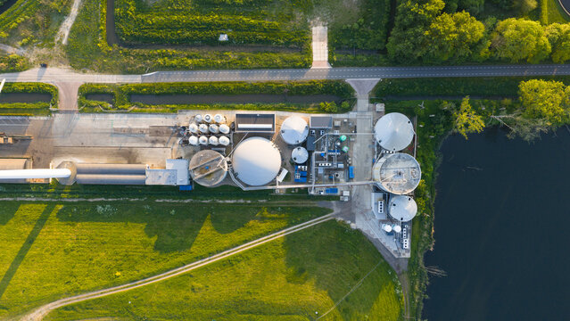 Aerial view of Wabico BV industrial facility and biogas plant featuring large circular storage tanks and complex piping systems in Waalwijk, Noord-Brabant, Netherlands.