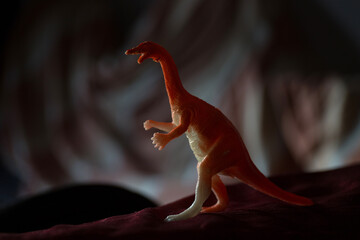 Plastic toy Dinosaur standing on a carpet © VectorDot