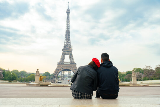 cheerful happy couple in love visiting Paris city centre and Eiffel Tower