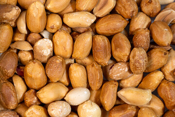 Obraz premium Roasted peanuts closeup texture, dry snack food macro background