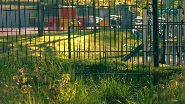 School gates with playground at dusk 