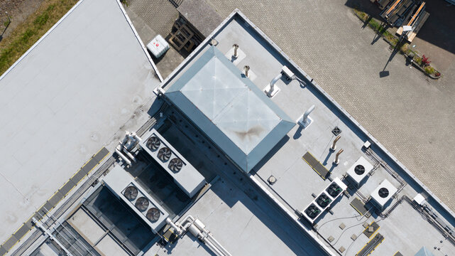 Aerial view of HVAC systems, ventilation units, and a central skylight on a flat industrial roof in Utrecht, Utrecht, Netherlands.