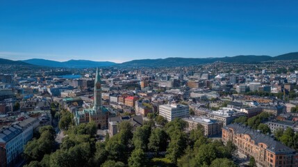 Obraz premium A stunning 4K drone panoramic over Oslo city center on a sunny summer day, featuring clear blue skies and mountainous backdrop, rich in vibrant detail and realism.