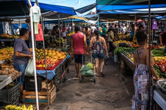 Open-air market with fresh fruits and vegetables in a popular market.