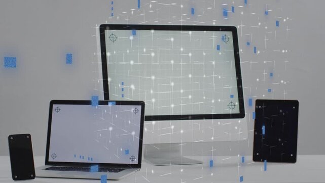 Blue particles appearing on frame one, drifting and filling across devices and highlighting screens