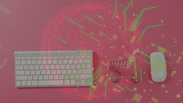 Red orb appearing sending circuit particles over keyboard cart mouse on pink backdrop, mapping data