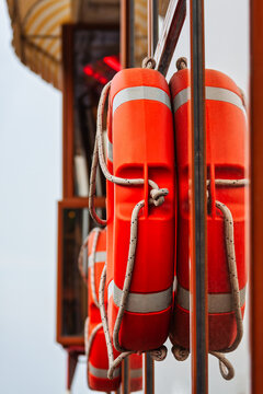 Orange Lifebuoy Rings Mounted on the Deck of a Passenger Ship deck structure while onboard.