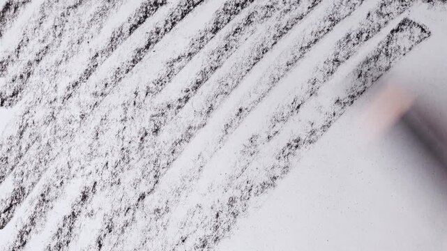 close up of charcoal pencil drawing on textured paper. slow motion footage. Background video can be used as overlay. doodling hatching