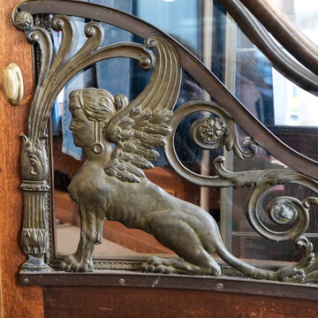 Art Nouveau griffin door detail with decorative metalwork