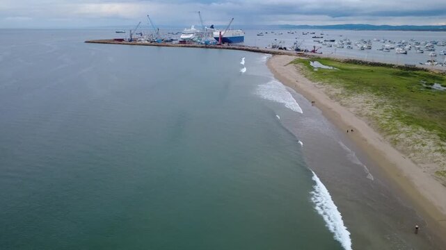 cruiser ship and cargo ship inside of Manta's seaport at late