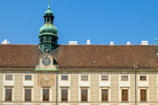 Historic clock tower facade under a clear blue sky