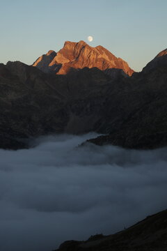 Pic of Vigmale under the moon: The towering peak pierces the clouds, under the glow of the moon, offering a mesmerizing display of nature's splendor.