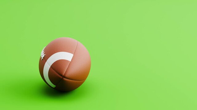 American Football Ball Rolling Slowly from Left to Right and from Right to Left on Green Background with Copy Space, Seamless Loop 3D Animation