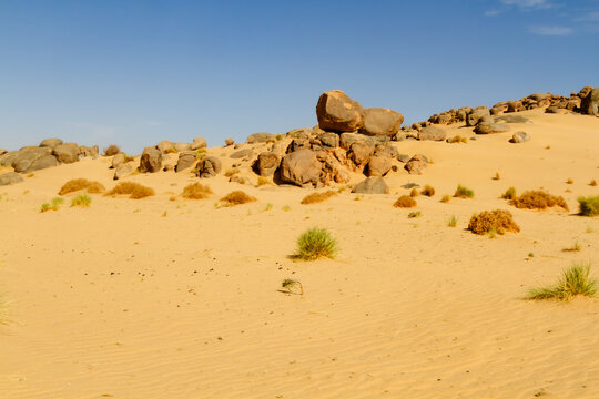 Sahara landscape. Rock formations with large, round boulders on a dune. Tassili n'Ajjer National Park, Algeria, Africa