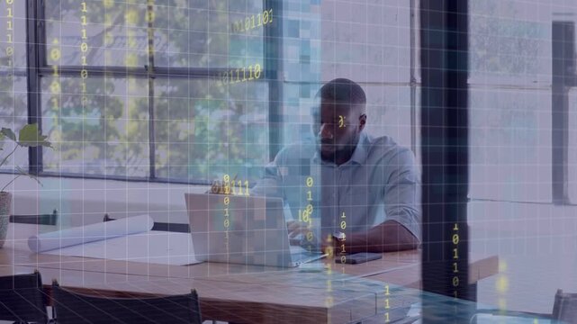 Man leaning typing laptop in office entering data checking phone plans binary overlay intensifying