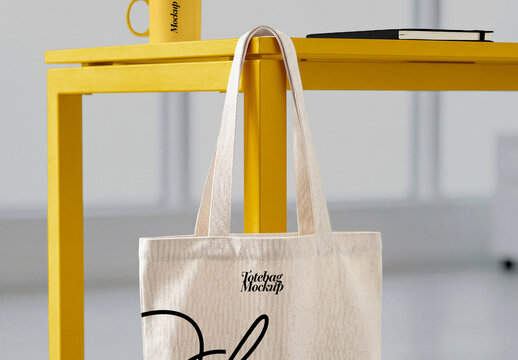 Canvas Tote Bag Hanging From Table in Studio Interior Mockup