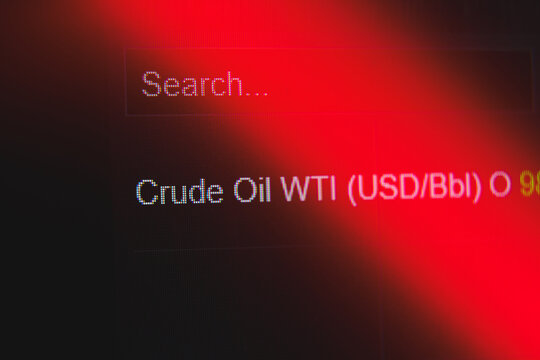 Close up of Crude Oil WTI market price data on a digital screen under red warning light, global energy crisis and rising fuel prices financial analysis concept