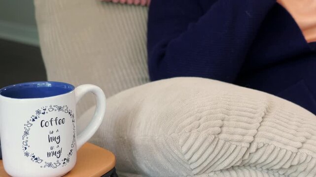 Man enjoys comfortable morning reading classical literature and drinking black coffee from cute mug - Comforts of working from home concept