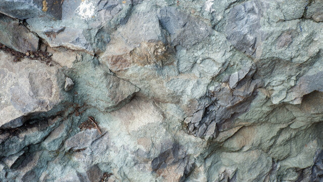 Jagged Blue-Grey Igneous Rock Surface 
Rough and sharp blue-grey igneous rock surface with intricate crystalline details and deep natural shadows
