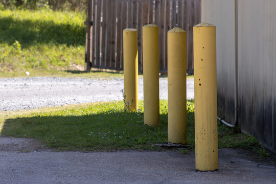A row of yellow parking bollards
