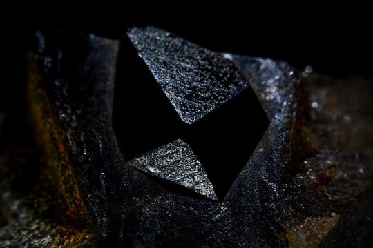 Macro shot of black Morion quartz crystal on dark natural stone background