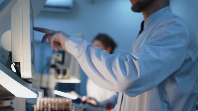 Scientists in modern laboratory conducting infectious disease analysis. Concept virology, epidemic research and global health protection focused on coronavirus and hantavirus.
