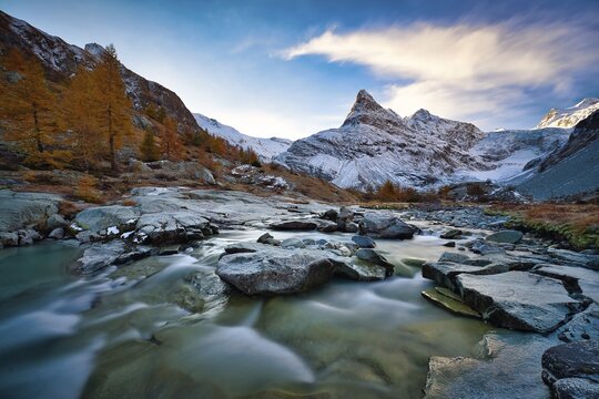 Morning atmosphere at the creek near Ferp&egrave;cle, behind it snowy Mont Min&eacute;, Val d'H&eacute;rens, Canton Valais, Switzerland
