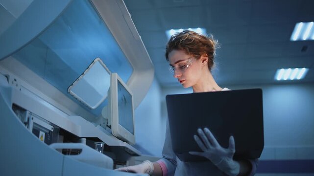 Medical researcher working on laptop configuring laboratory software and diagnostic systems. Concept modern science, biomedical technology and epidemic research including coronavirus and hantavirus.
