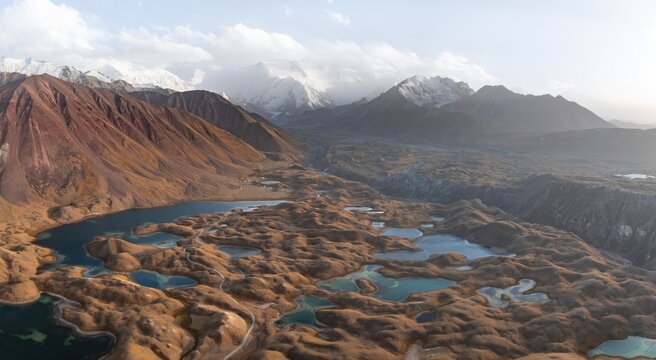 Atmospheric aerial view, high mountain landscape with glacier moraines and mountain lakes, behind Pik Lenin, Trans Alay Mountains, Pamir Mountains, Osher Province, Kyrgyzstan