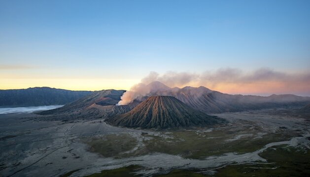 Volcanic landscape at sunrise, smoking volcano Gunung Bromo, with Mt. Batok, Mt. Kursi, Mt. Gunung Semeru, Bromo-Tengger-Semeru National Park, Java, Indonesia