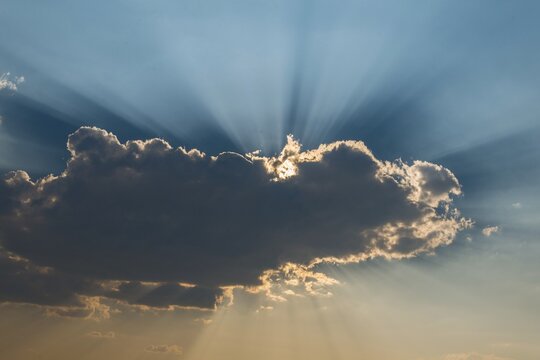 Sun shining behind a cloud, Etosha National Park, Namibia