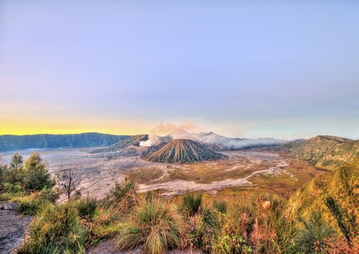 Sunrise, smoking volcano Mount Bromo, Mt. Batok at front, Mt. Kursi at back, Mt. Gunung Semeru, Bromo Tengger Semeru National Park, Java, Indonesia