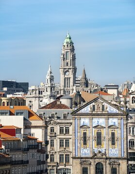 View on the facade of the church Igreja de Santo Ant&oacute;nio dos Congregados, at the back tower of the town hall C&acirc;mara Municipal do Porto, Porto, Portugal