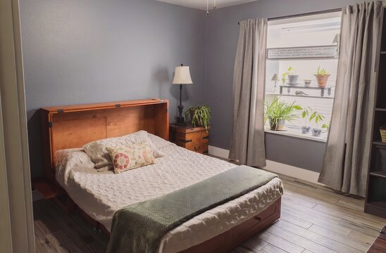 interior of a bedroom with open murphy cabinet